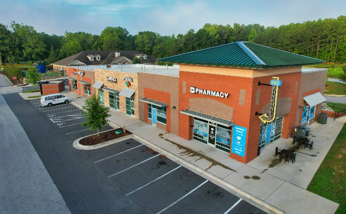 an aerial view of a building with a parking lot